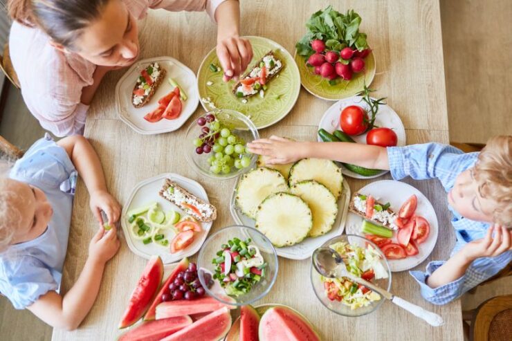 Son having healthy meal with mother and sister